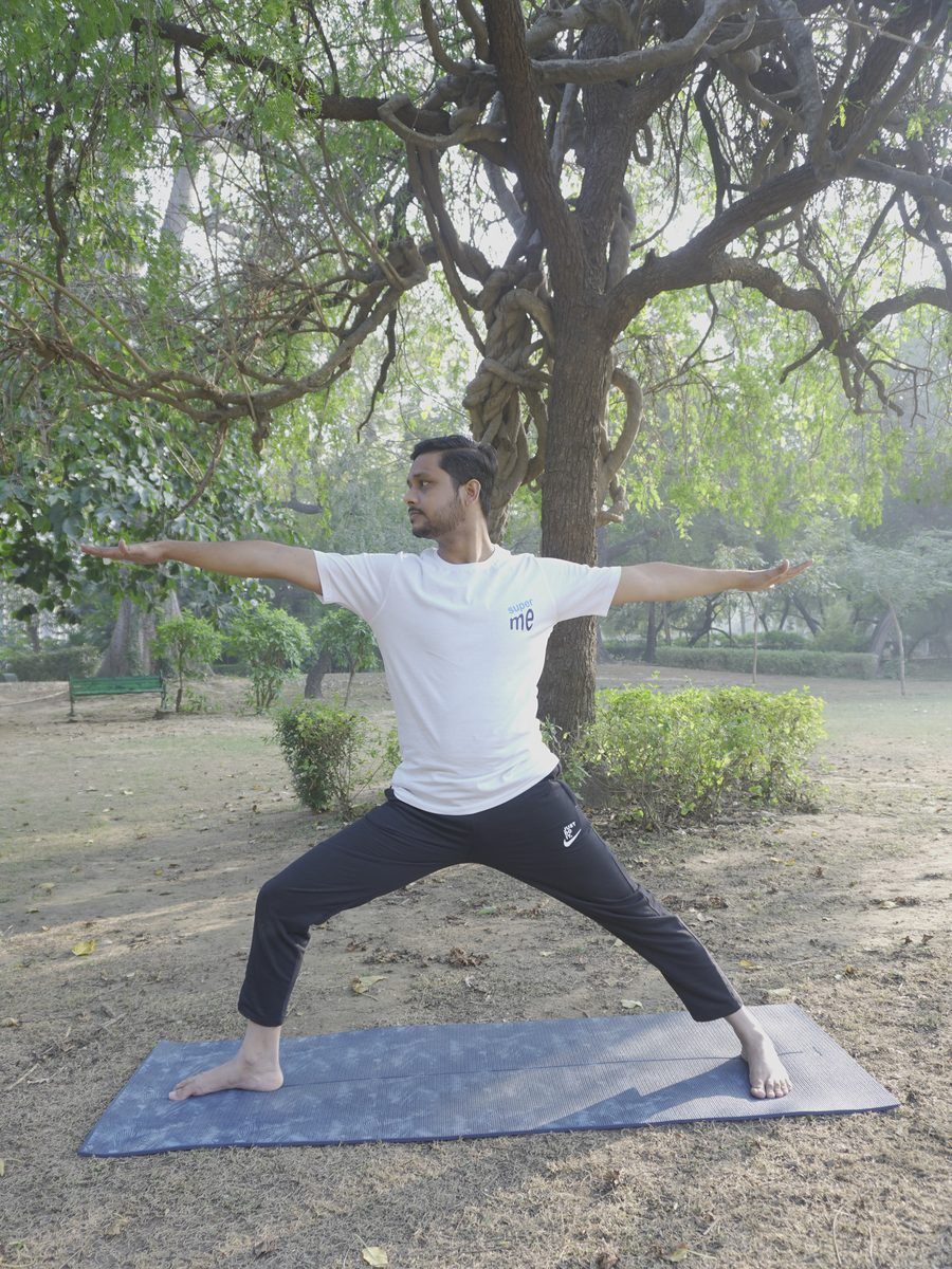 Atul Mishra in a standing warrior posture